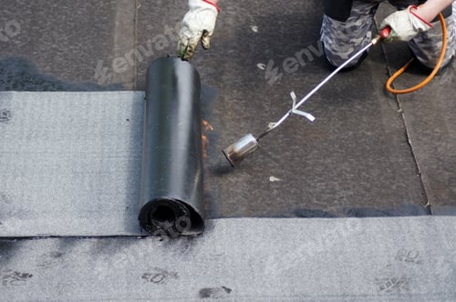 Preview: Flat roof installation with propane blowtorch during construction works with roofing felt