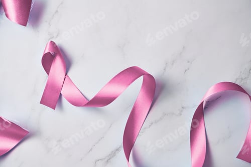 Preview: Pink ribbon on white marble background, breast cancer day.
