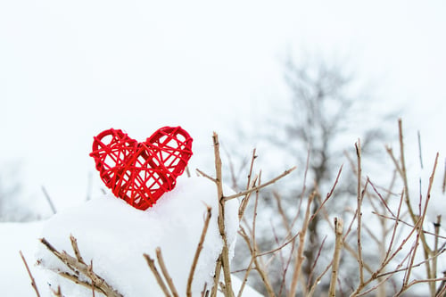 Preview: Wooden red heart on background of snow-covered tree branches. Eco-friendly valentines day. Symbol of
