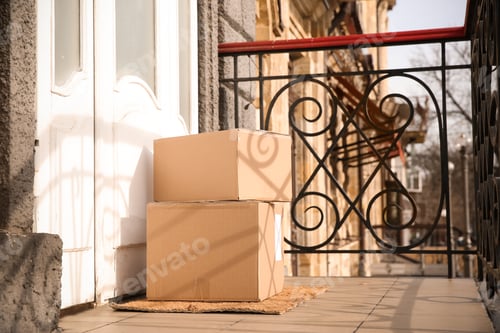 Preview: Delivered parcels on door mat near entrance