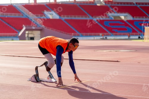 Preview: Asian para-athletes with prosthetic blades sprint on a running track at stadium.
