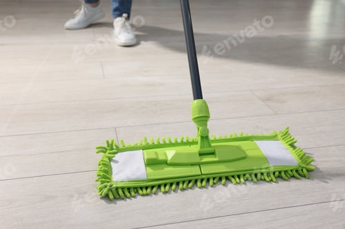 Preview: Woman cleaning floor with microfiber mop indoors, closeup