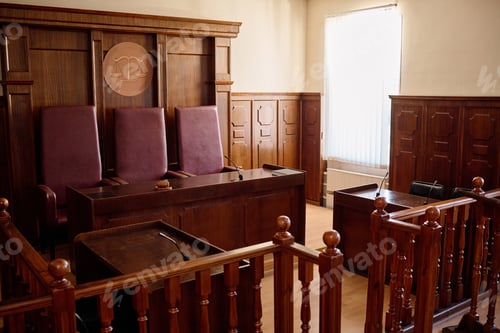 Preview: Part of spacious courtroom with wooden furniture and leather chairs