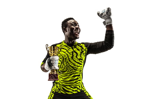 Preview: The winner soccer player with ball isolated on white background