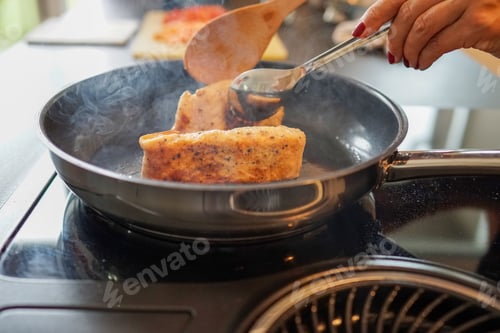 Preview: Closeup of delicious salmon being cooked on a stove