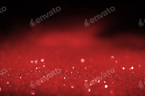Preview: abstract blurred red glitter on dark background