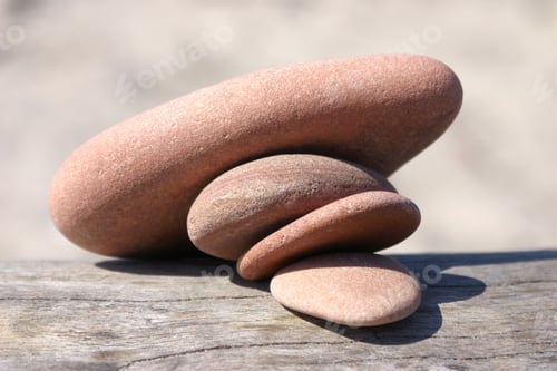 Preview: Four pebble stones pressing each other and collapsing