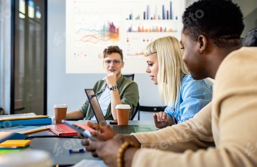 Preview: Diverse group of young business people working on new project together in office.