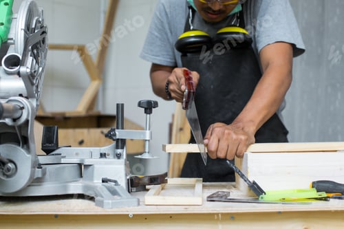 Preview: Carpenter sawing wooden planks