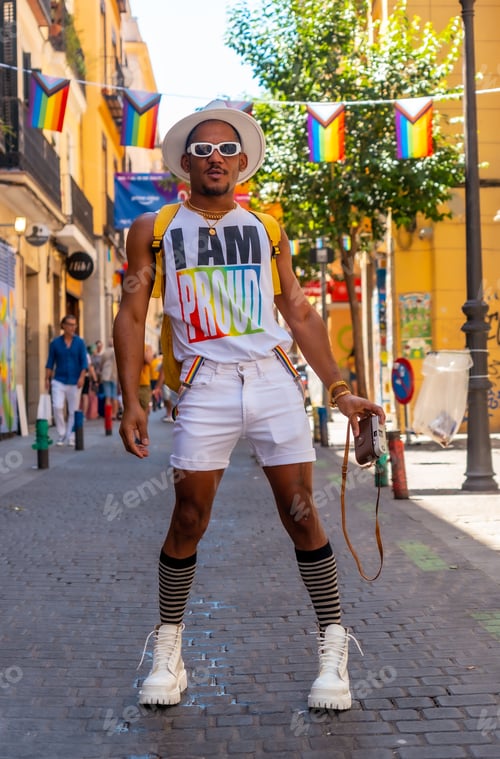 Preview: Portrait of a gay black man at the pride party taking photos, LGBT flag