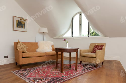Living Room with Couch, Armchair, and Area Rug