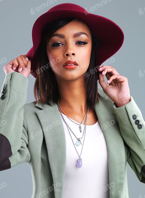 Preview: Studio portrait of a stylish young woman posing against a gray background