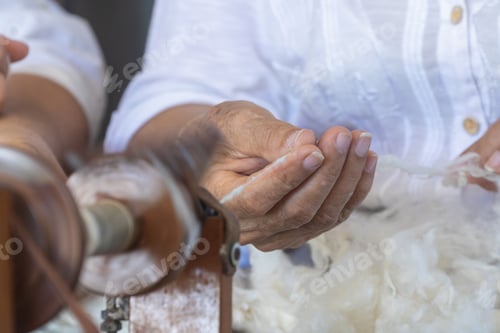 Preview: Close-up of hands skillfully extracting silk thread in a traditional artisanal manner