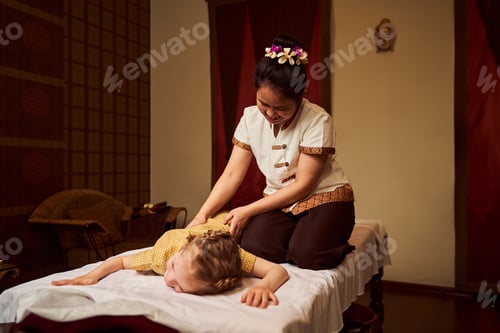 Preview: Girl at massage session. Spa salon and masseuse