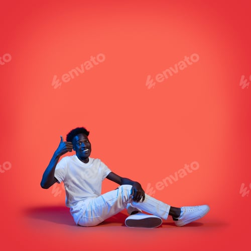 Preview: Cool black guy sitting on floor, showing thumb up
