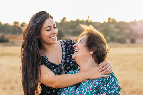 Preview: Taking advantage of life Grandmother and granddaughter in a field of sunflowers.