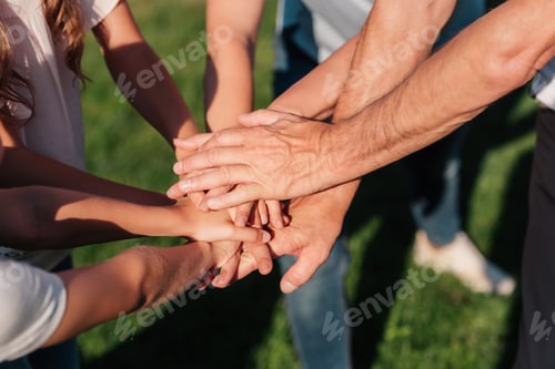 Preview: partial view of family holding hands together