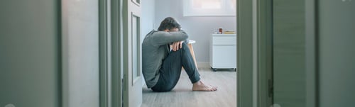 Preview: Man with mental disorder crying sitting on room floor