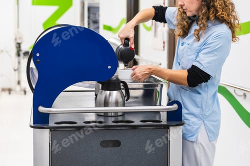 Preview: Unrecognizable Nurse Serving Coffee in Hospital Corridor