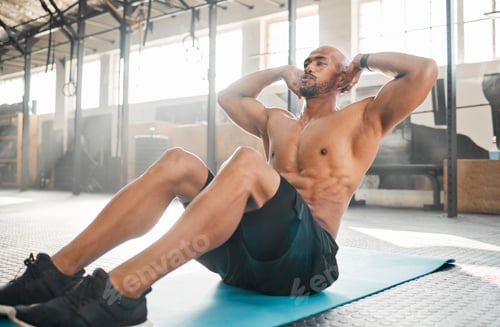 Preview: Keep your core engaged. Shot of a young man completing crunches.