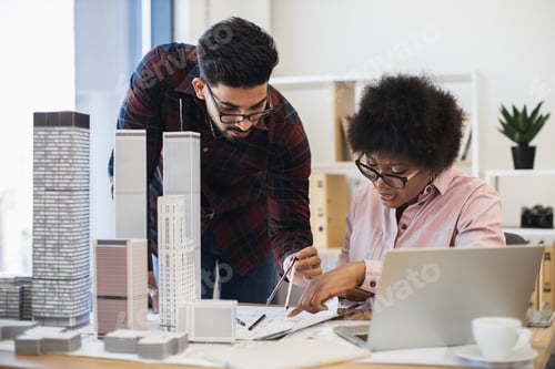 Preview: Architects collaborating on modern city design project in office