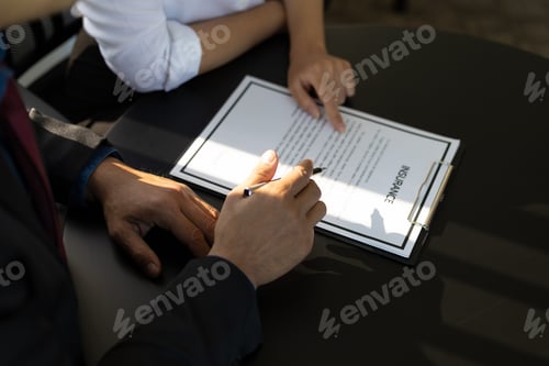 Preview: Businessman showing an insurance policy to sign. Insurance agent consulting insurance to customer.