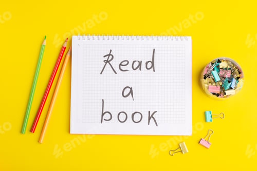 Preview: top view open copybook with colorful pencils on yellow background paint drawing color art draw