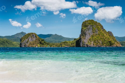 Preview: El Nido, Philippines. Crystal clear blue water lagoon and private Malapacao island in background