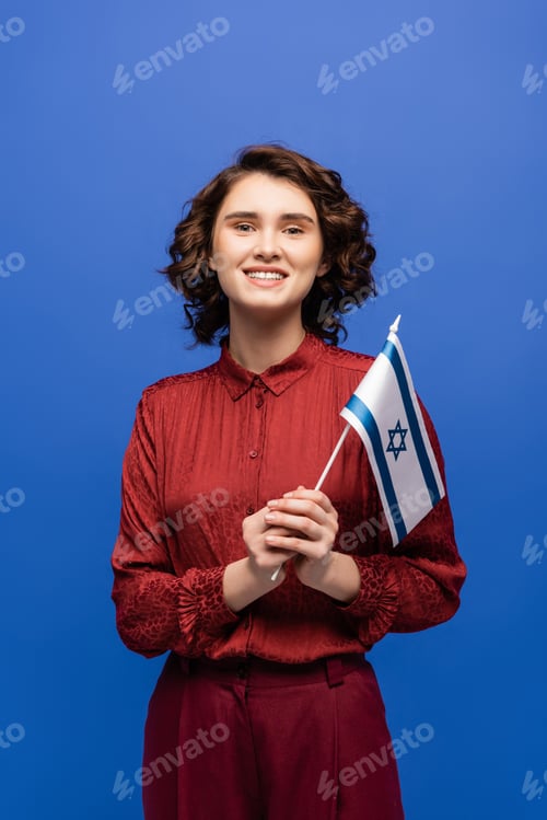 Preview: cheerful teacher of Hebrew language holding flag of Israel isolated on blue