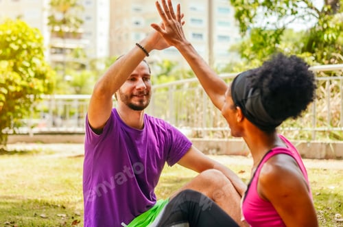 Preview: Cheerful couple clap their hands high five after exercising achievement.