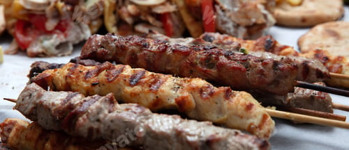 Preview: Mixed grilled meat platter, pork and chicken meat skewers, kebab pieces, closeup