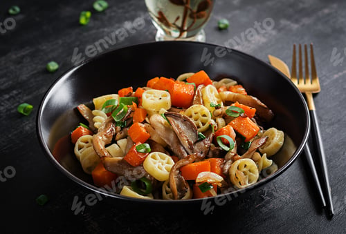 Preview: Rotelle pasta gluten free with mushrooms and pumpkin on a dark background.