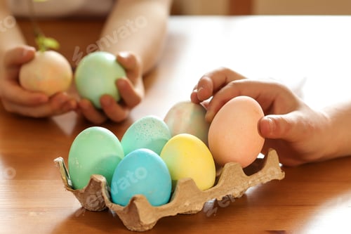 Preview: The girls help their mother in preparing for Easter. Easter eggs. Pastel shades. hands close up