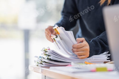 Preview: Asian Business woman using calculator and laptop for doing math finance an office desk, tax, report,