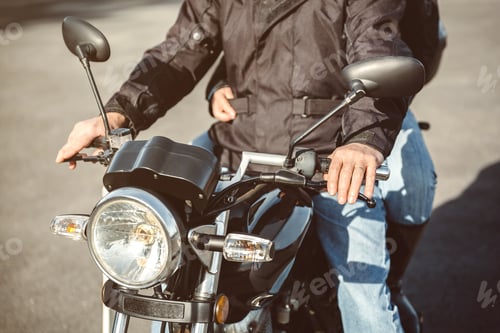 Preview: Senior man steering motorcycle on road