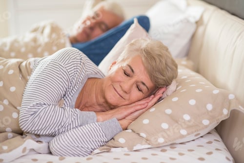 Preview: Woman and her husband sleeping comfortably