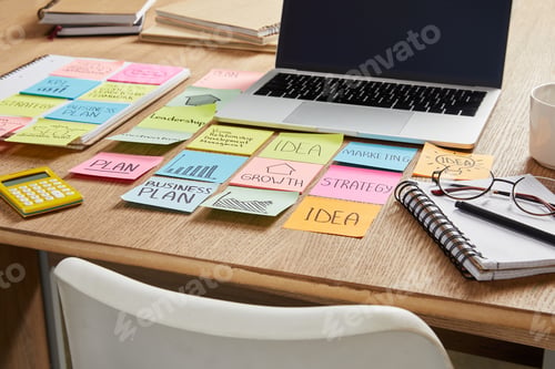 Preview: colored paper stickers with business strategy and laptop on tabletop