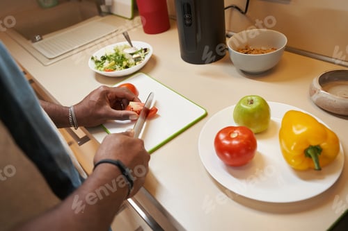 Preview: Man using big knife for cutting vegetables on table