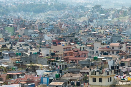 Preview: View of a bustling cityscape with vibrant and colorful old buildings on sunny day