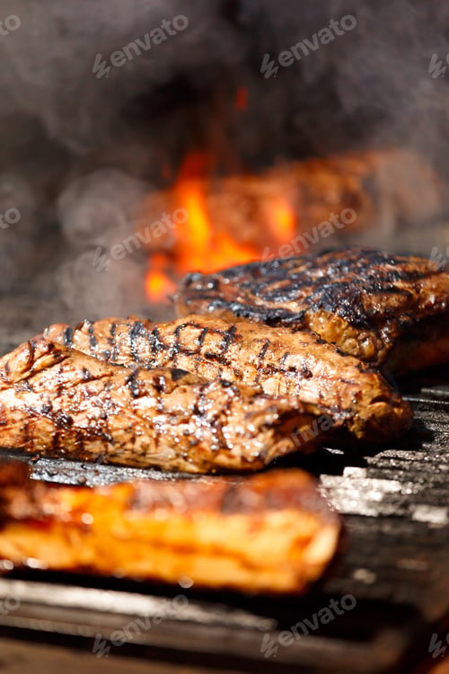 Preview: Juicy meat steaks and fillets are grilled