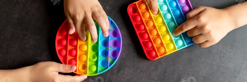 Preview: kids anti stress sensory pop it or simple dimple fidget push toys in kid's hands. playing with a toy