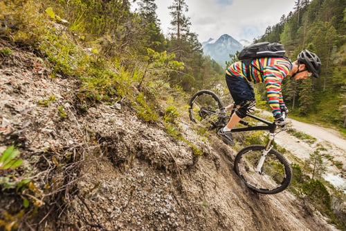 Preview: Mountain biker tackling a rugged trail in the forest