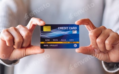 Preview: Closeup image of a woman holding and showing credit card