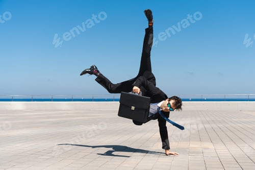 Preview: Flexible and cool businessman doing acrobatic trick