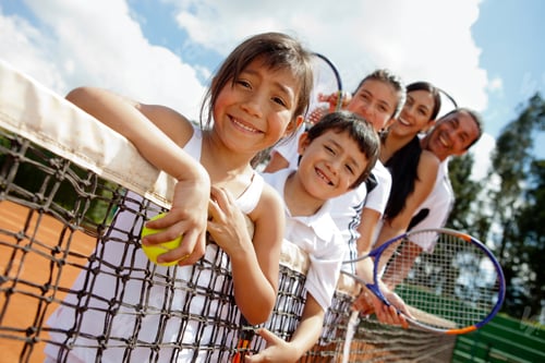 Preview: Family Of Tennis Players At The Court Next To The Net