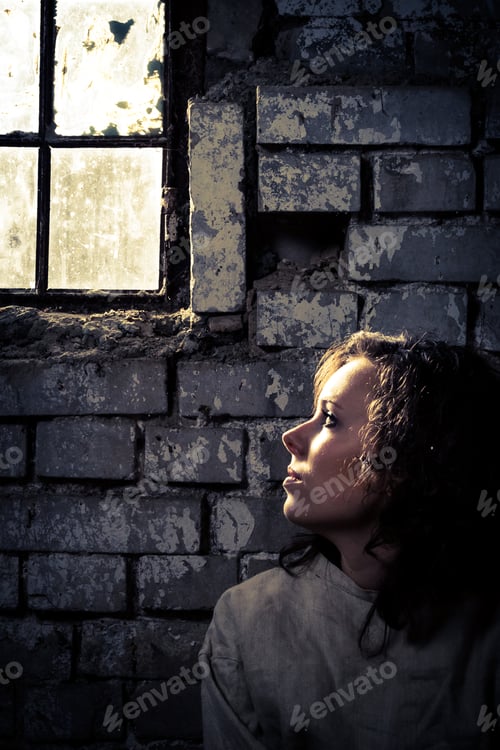 Preview: Woman wearing straitjacket in a dirty prison