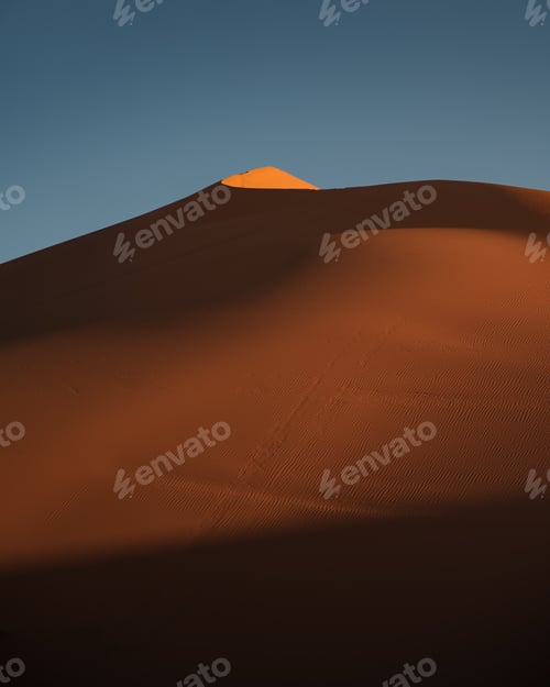 Preview: Majestic sand dunes of erg chebbi bathed in golden light during sunset in the sahara desert