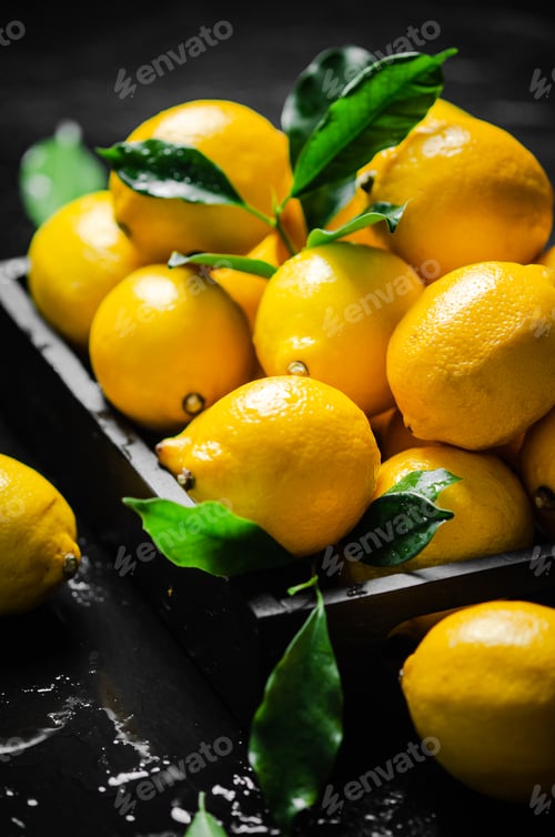 Preview: Fresh lemons. On black table.