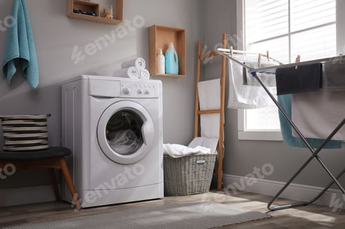 Preview: Laundry room interior with modern washing machine near light wall