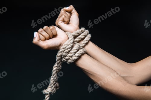 Preview: cropped shot of female hands bound with rope isolated on black